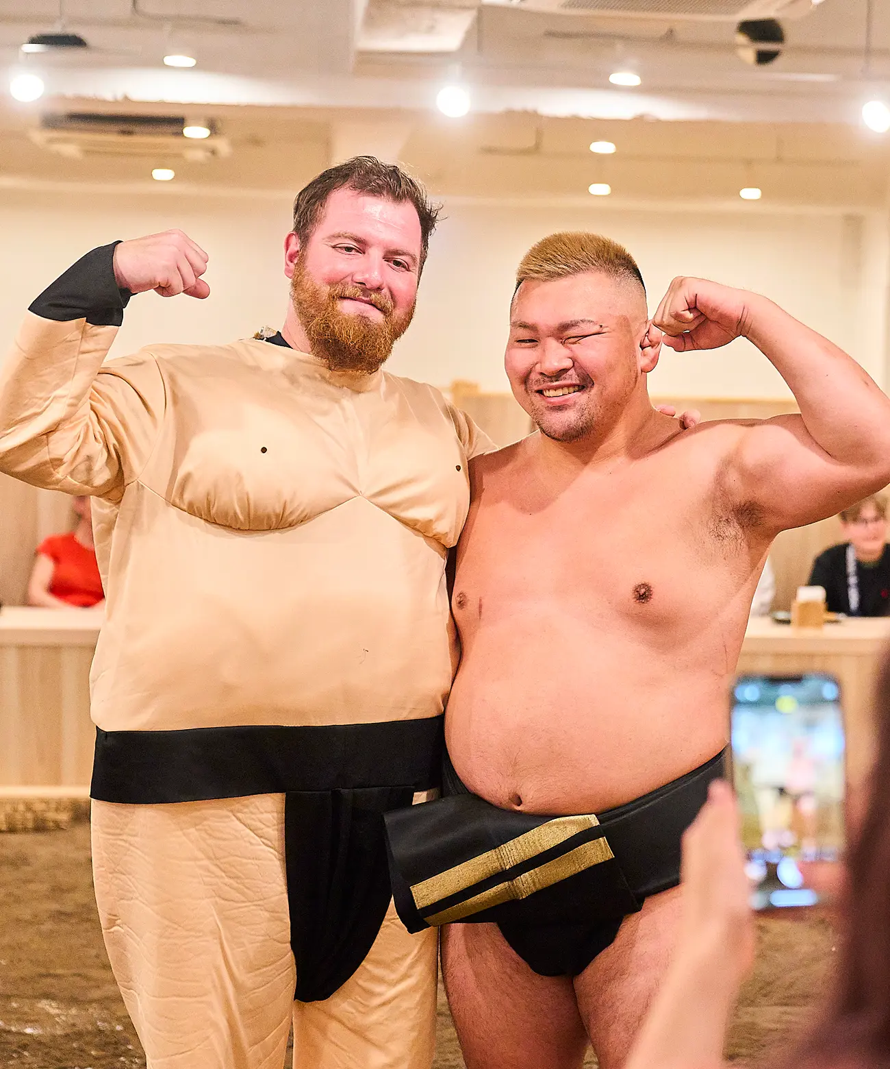 Sumo wrestler and guests during a sumo experience