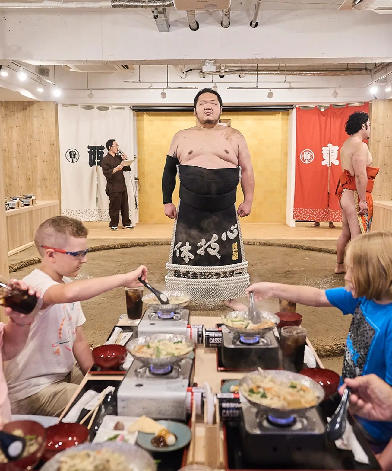 Sumo wrestler and guests enjoying chanko dining